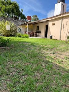 a house with a grass yard in front of it at La posada de Rufina in Reyes