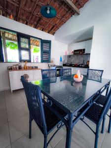 einen Esstisch mit Stühlen in der Küche in der Unterkunft Casa Mahalo - no centro de Cumbuco in Caucaia