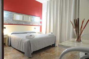 Postel nebo postele na pokoji v ubytování Hotel del Ponte