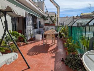 a patio with a chair and an umbrella on a balcony at Apartment near Fira Barcelona, Camp Nou, and the center of Barcelona in Hospitalet de Llobregat