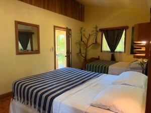 Postel nebo postele na pokoji v ubytování Finca Ometepe