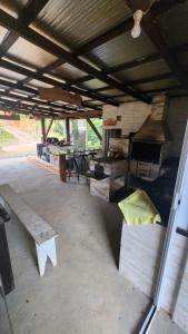 un patio con panchine, tavolo e grill di Rancho do Brow a Camboriú Altre 6 foto