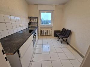 a small kitchen with a counter and a window at RHE 6P Unterkunft in Rheine