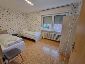 a small bedroom with a bed and a window at RHE 6P Unterkunft in Rheine