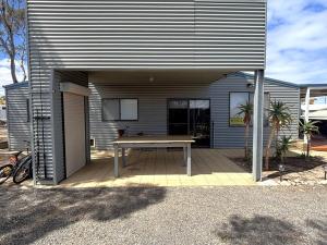 a patio with a table in front of a house at Brooksea at Balgowan in Balgowan