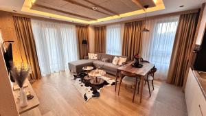 a living room with a couch and a table at Snowfall Luxury Suites Jahorina in Jahorina
