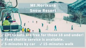 a group of people riding a ski lift in the snow at Raicho Onsen Inn in Matsumoto