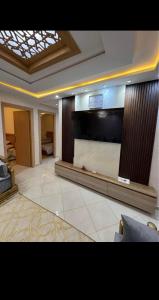 a living room with a large flat screen tv at Residence Ritaj in Agadir +1 photo