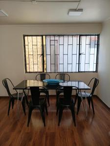 a room with two tables and chairs and stained glass windows at Casa Quinta Vergara in Viña del Mar