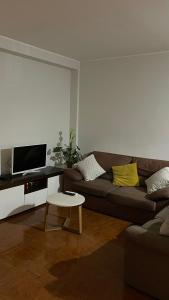 a living room with a couch and a table at The Calm Residence - Gondomar 