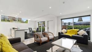 a living room with two couches and a table at Diamond Luxury Central Queenstown in Queenstown