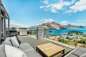 a living room with a view of the water at Lake Panorama Villa in Queenstown