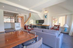 a living room with a couch and a table at The Lodges in Queenstown