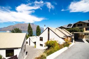 arial view of a house with mountains in the background at The Lodges in Queenstown