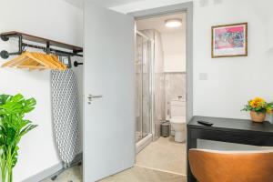 a room with a desk and a chair next to a door at The City Pad in Nottingham +170 photos