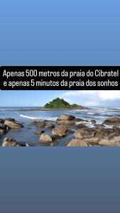 a beach with rocks and water at Casa de condomínio com piscina e churrasqueira in Sao Paulo