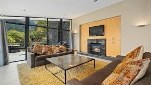 ein Wohnzimmer mit Couch und Kamin in der Unterkunft The Haddens in Queenstown + 25 Fotos
