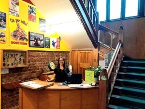 a woman sitting at a counter in a restaurant at Noah's Ark Flashpacker in Greymouth +86 photos