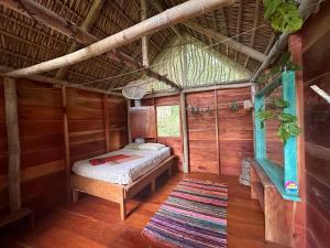 a bedroom with a bed in a wooden house at Writer's Cabin in Santa Cruz