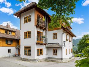 a large white building with windows and balconies at Fanningberg in Mariapfarr