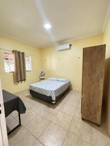 a bedroom with a bed and a chair in it at Sitio Família Freitas in Pindoretama +28 photos