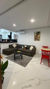 a living room with a couch and a table at Dolce Vita Appartement in El Aouina Station