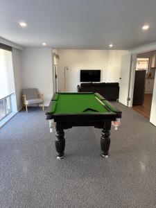 a living room with a pool table in it at The Townhouse in Renmark +4 photos