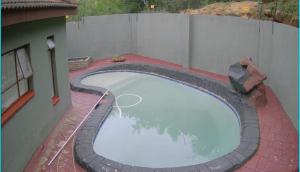 an overhead view of a large swimming pool on a building at BTV Villa in Hazyview