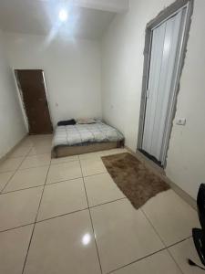 a bedroom with a bed and a large window at Mares in Mairiporã