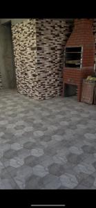 a room with a tile floor and a brick wall at Mares in Mairiporã