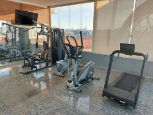 a gym with several tread machines in a room at Flat com Piscina e Academia in Uberaba