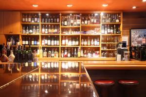 a bar with a lot of bottles of alcohol at Hakkoda Hotel in Aomori