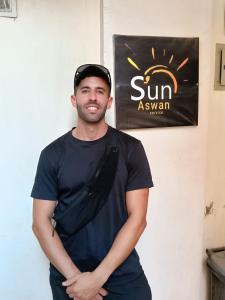 a man standing in front of a sun asian sign at Sun Aswan inn in Aswan +18 photos