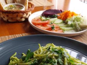 a table with two plates of food and a plate of vegetables at Hostel 566 in La Serena
