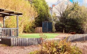 a backyard with a fence and a gate at Nant caer Efail Cottage - Stream by the forge in Pen-y-cae