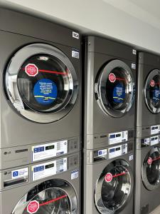 three washing machines are stacked next to each other at Apartaestudio Centro Internacional UTEK in Bogotá
