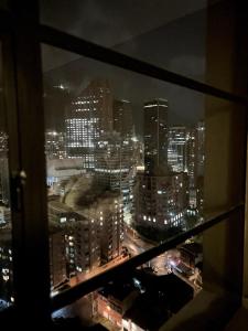 a view of a city at night from a window at Apartaestudio Centro Internacional UTEK in Bogotá +13 photos