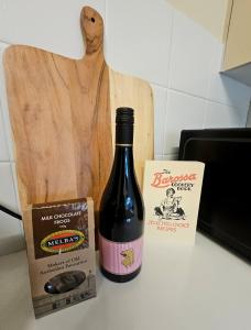 a bottle of wine and a box of chocolates at Neat & Tidy Family Home with Beautiful Back Yard in Angaston +9 photos