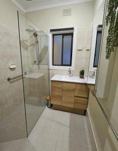 a bathroom with a shower and a sink at Neat & Tidy Family Home with Beautiful Back Yard in Angaston