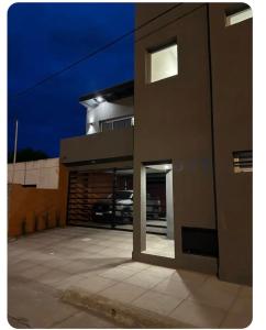 a building with a garage with a car in it at Modern apartment in Azul, comfort and style with patio in Azul