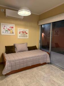 a bedroom with a large bed in a room at Modern apartment in Azul, comfort and style with patio in Azul
