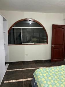 Schlafzimmer mit einem großen Fenster und einem Bett in der Unterkunft Datecsofts Headquarters in Los Baños del Inca