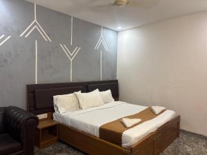 a bedroom with a bed and a chair at Heaven's Crest in Chennai