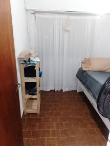 a small room with a bed and a window at Departemento Garay in San Bernardo +1 photo