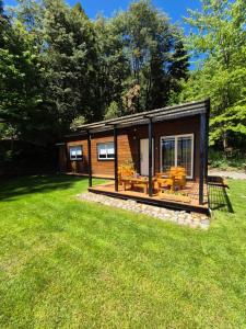 a small cabin in a field of grass at Tiny House Melgarejo in San Carlos de Bariloche +12 photos