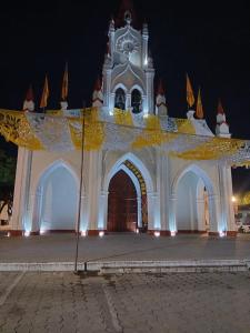 a large white building with a clock tower at night at Jardín de Los Sueños Quinta San Felipe in Antigua Guatemala