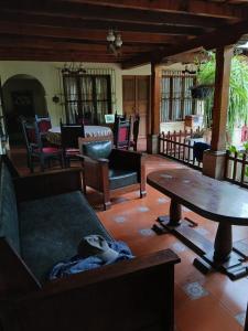 a living room with a couch and a table at Jardín de Los Sueños Quinta San Felipe in Antigua Guatemala