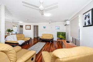a living room with two couches and a tv at Townsville Accommodation in Low-Maintenance Living in Aitkenvale