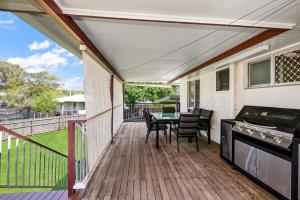 a patio with a table and chairs on a deck at Townsville Accommodation in Low-Maintenance Living in Aitkenvale