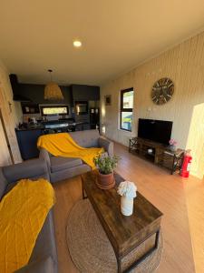 巴拉斯港Loft Río Maullín, naturaleza y descanso de la mano con la modernidad的客厅里有一张沙发和一张桌子。